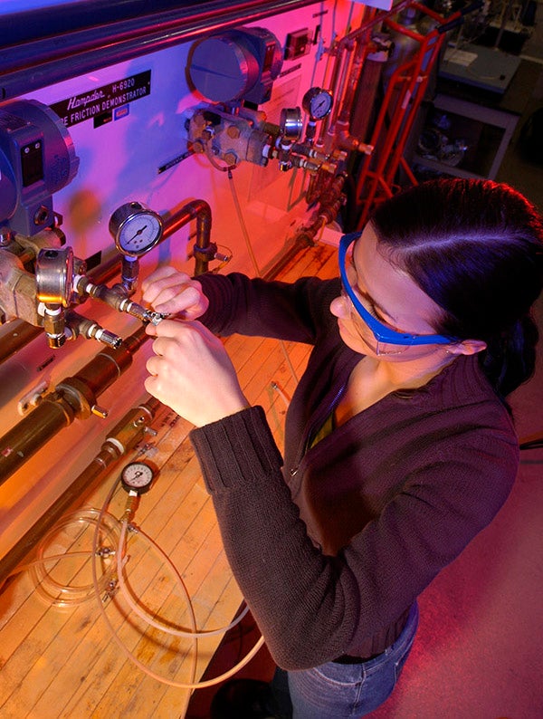 student with lab equipment