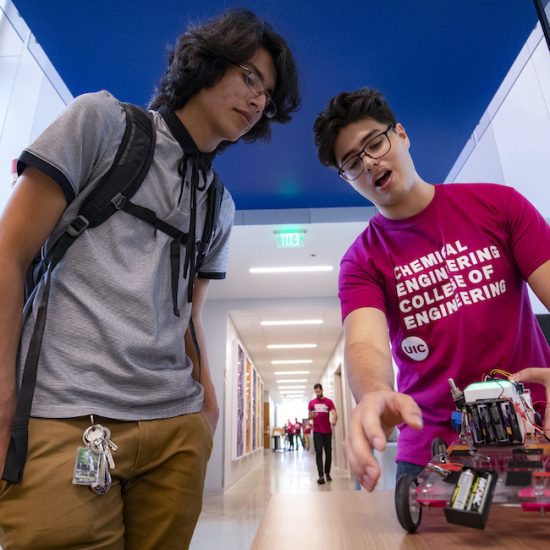two students examine the chemical engineering model car