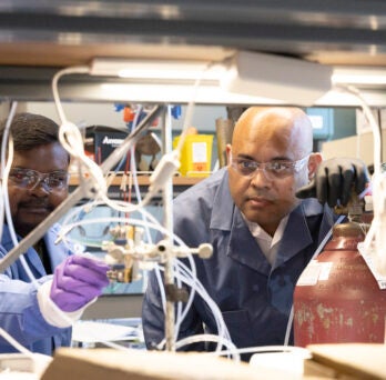 Associate Professor Meenesh Singh, right, and postdoctoral researcher Rohit Chauhan work in Singh’s laboratory at the University of Illinois Chicago.
                  