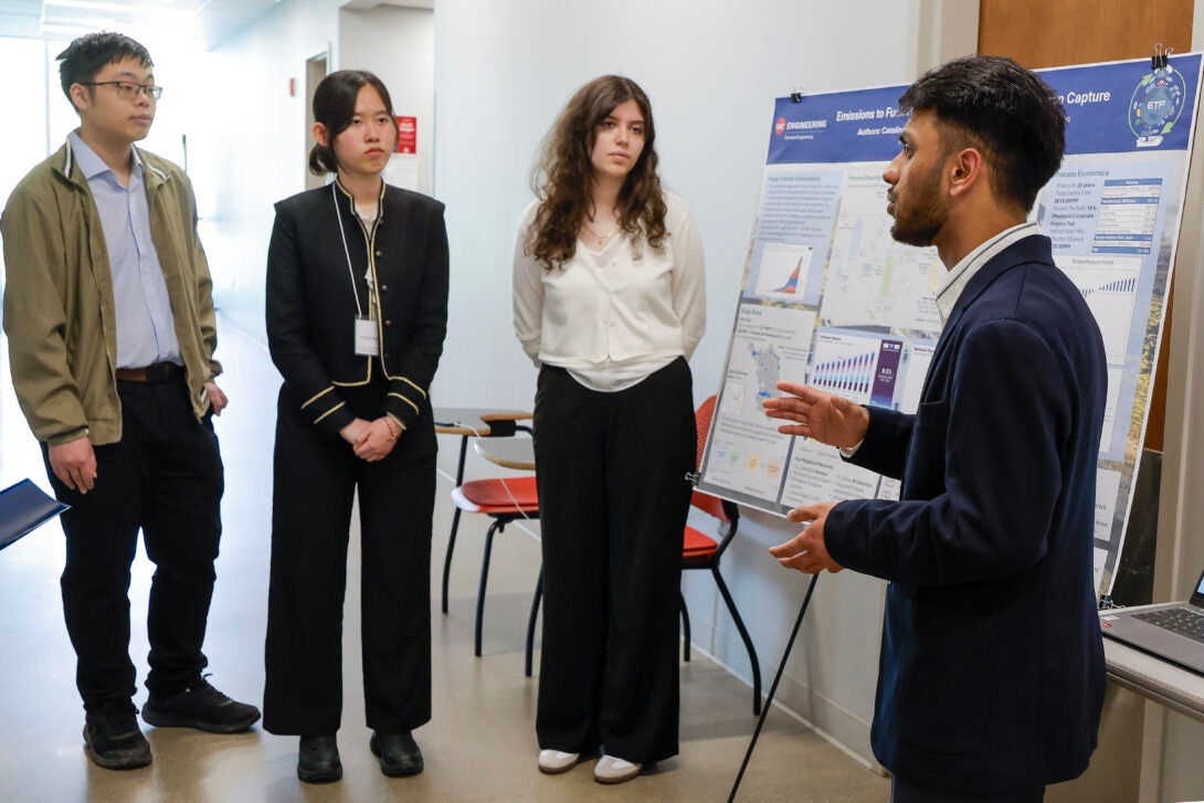 University of Illinois Chicago College of Engineering CHE senior Varun Maheshwari discusses his group's research poster at the Design Showcase as an addition to the Expo senior design event at EIB, April 28, 2025.